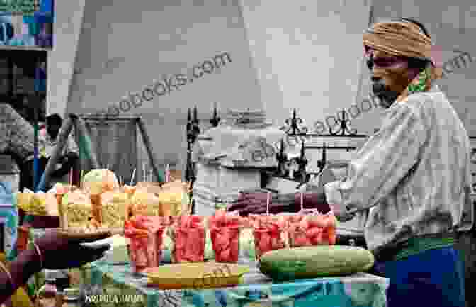 A Vibrant Street Scene In Bombay, With People Walking, Vendors Selling Goods, And Colorful Buildings Lining The Street. Bombay Smiles Jaume Sanllorente