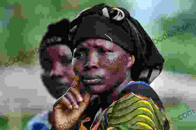 A Woman In The Democratic Republic Of Congo Stands In Front Of A Destroyed Building. She Is Holding A Sign That Says 'Stop Gender Violence.' Gender Violence And Politics In The Democratic Republic Of Congo (Gender In A Global/Local World)