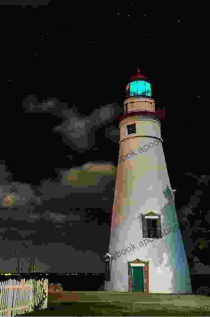 An Eerie Photograph Of A Lighthouse Bathed In Moonlight, Its Windows Aglow With A Mysterious Light. Ghosts And Legends Of The Carolina Coasts