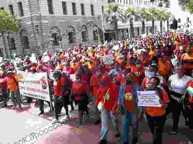 Workers Marching In Protest, Demanding Improved Health And Safety Standards In Their Workplace. The Struggle For Workers Health